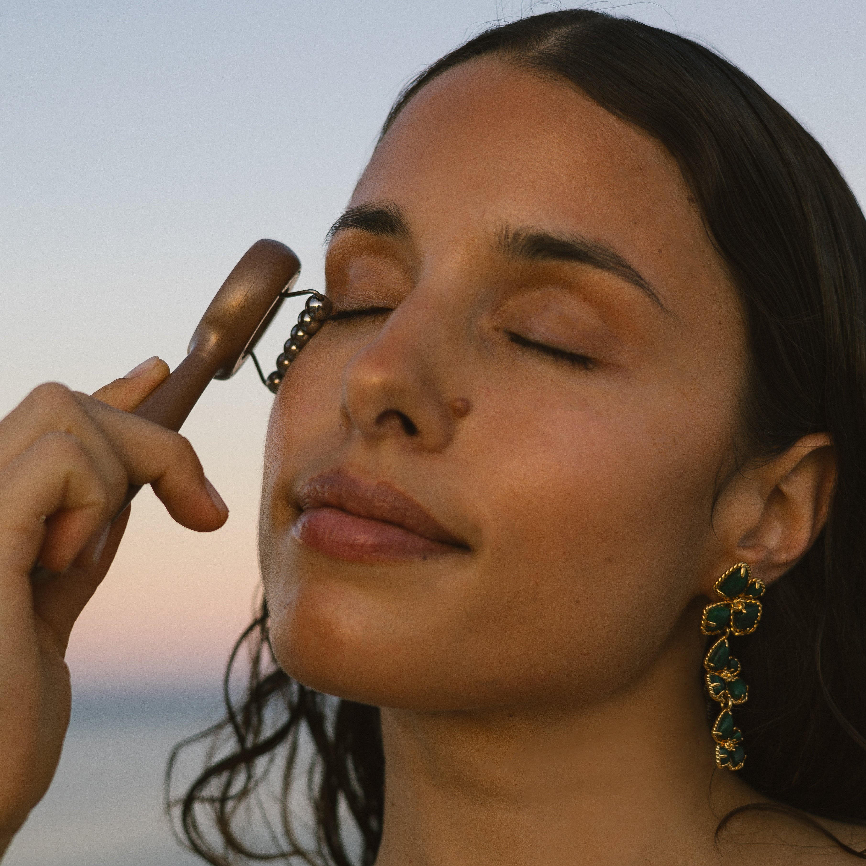 Woman using Eco By Sonya Face Workout on her face