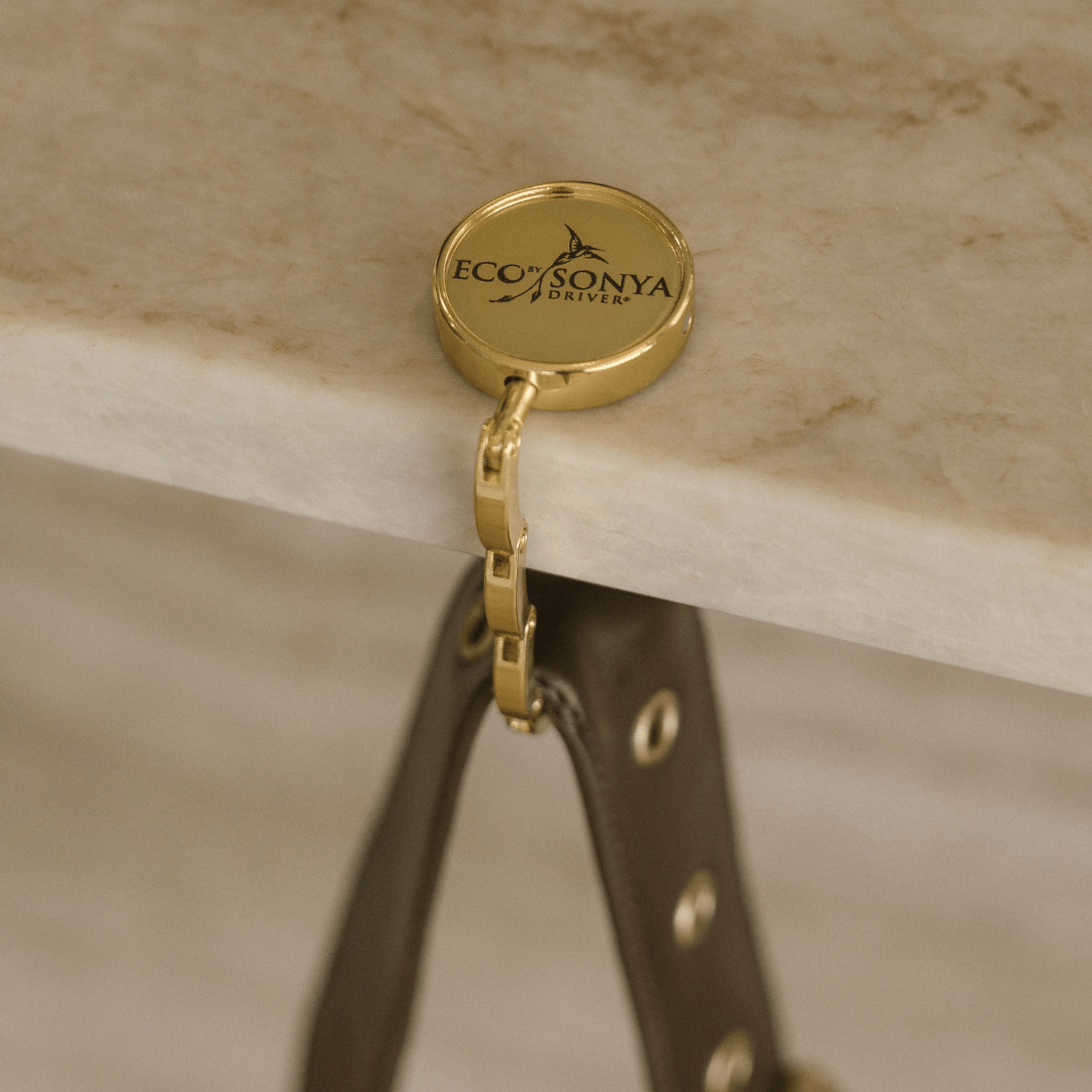 Eco by Sonya logo gold back hook on marble table