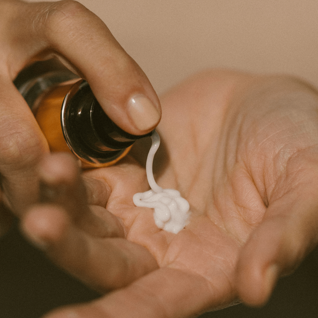 Hand holding Super Fruit Hydrator Moisturiser being dispensed onto the palm.