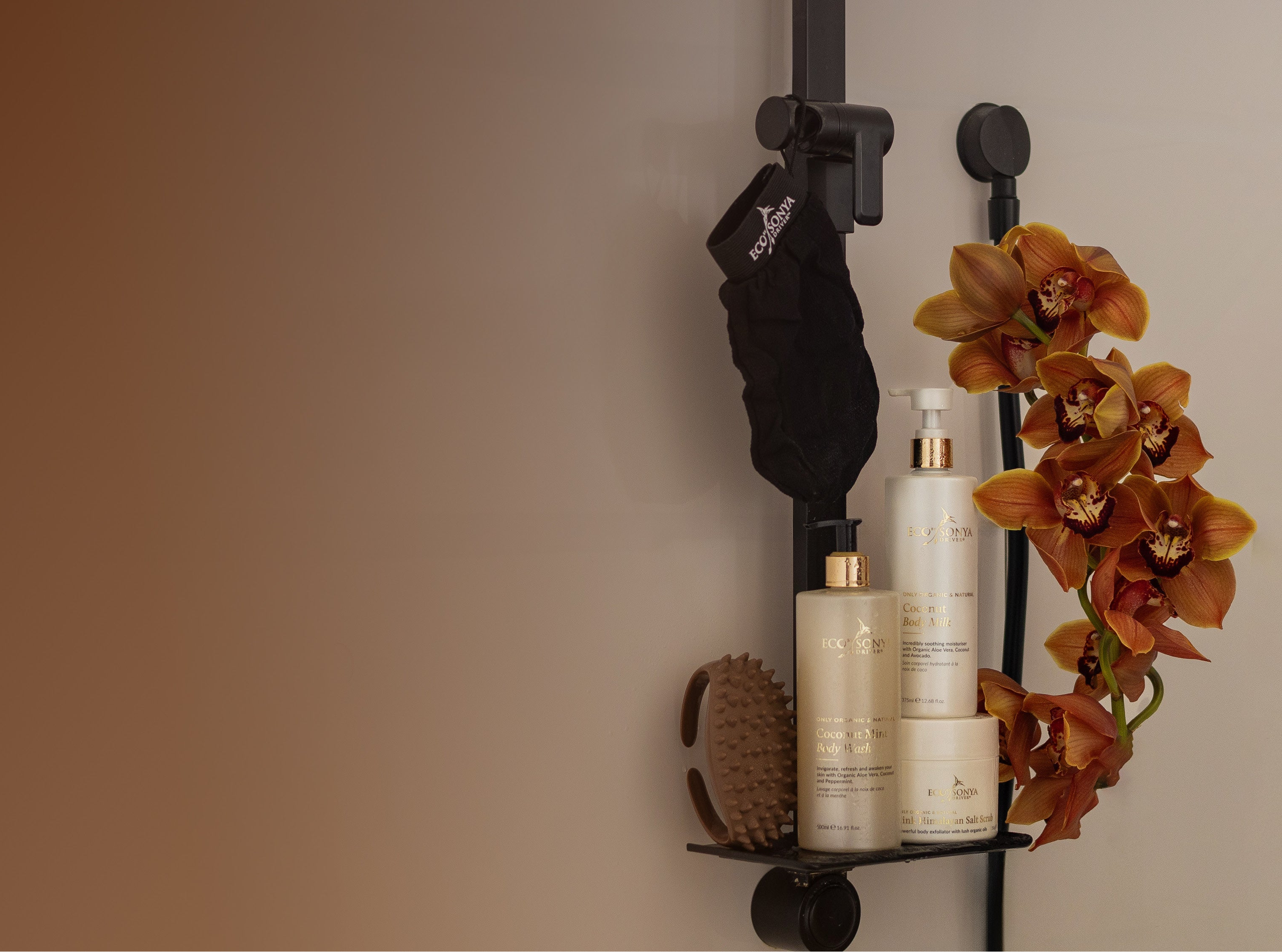 Bathroom shelf with Eco By Sonya Smooth Body Kit products and a decorative orchid on a neutral background